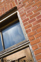 Window Above Front Entrance And Red Brick